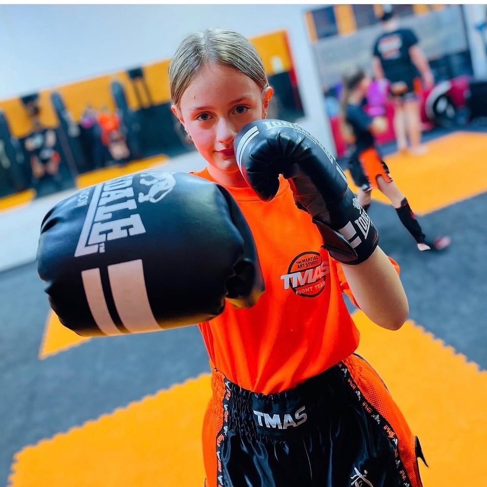 Children practising martial arts and kickboxing drills