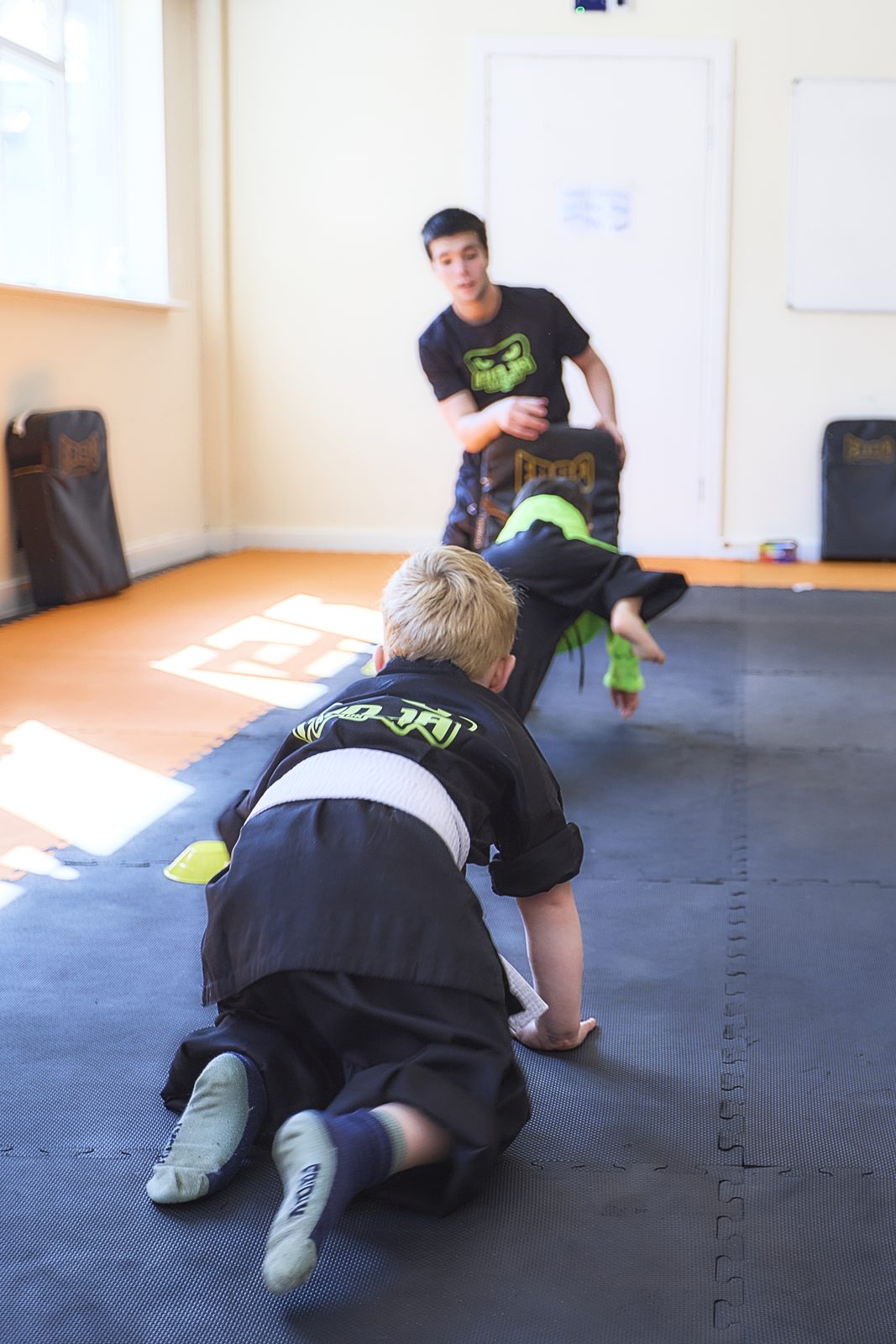 Children practising martial arts pad drills in West Kirby