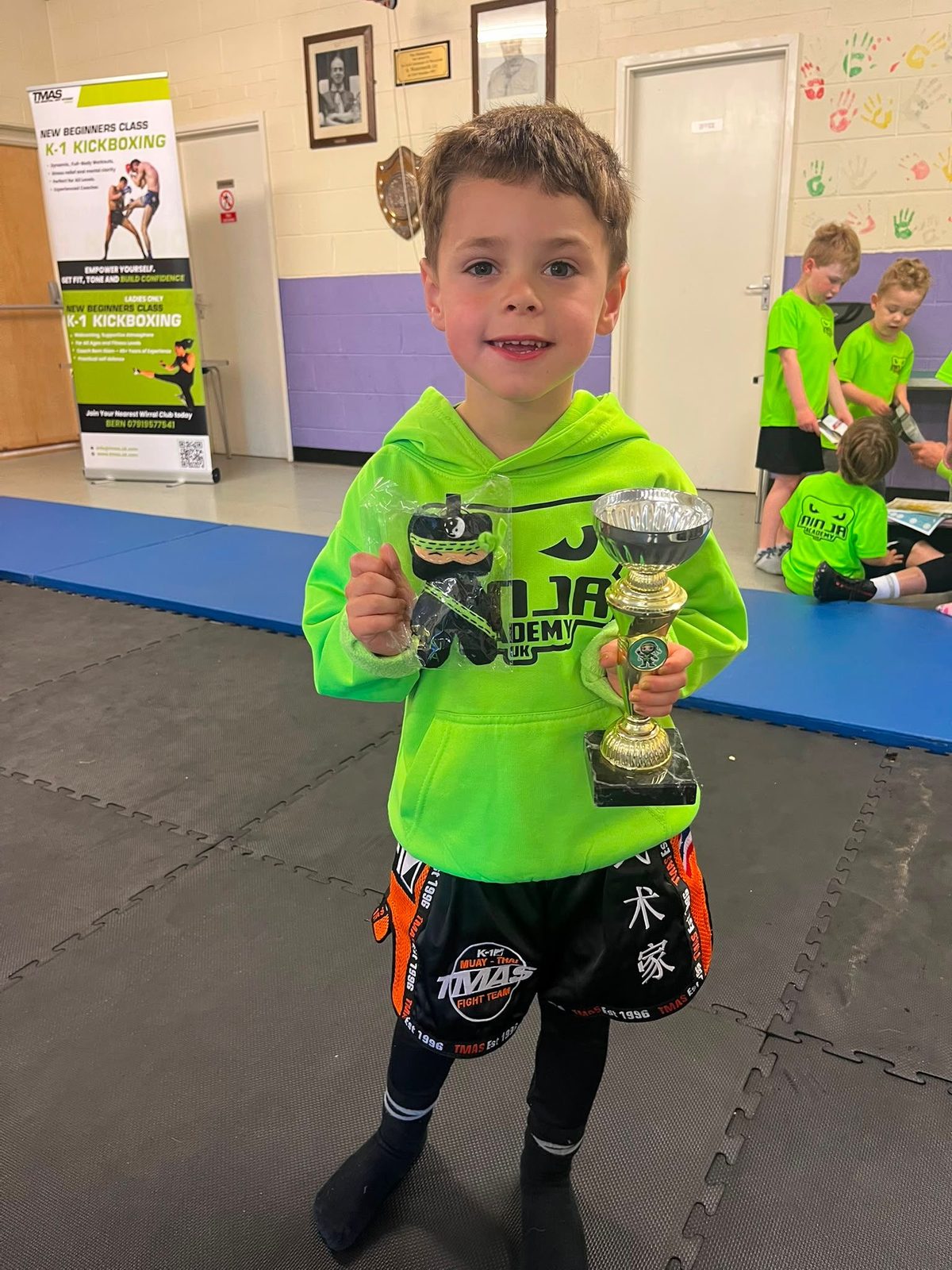 Young student receiving Little Ninjas achievement certificate