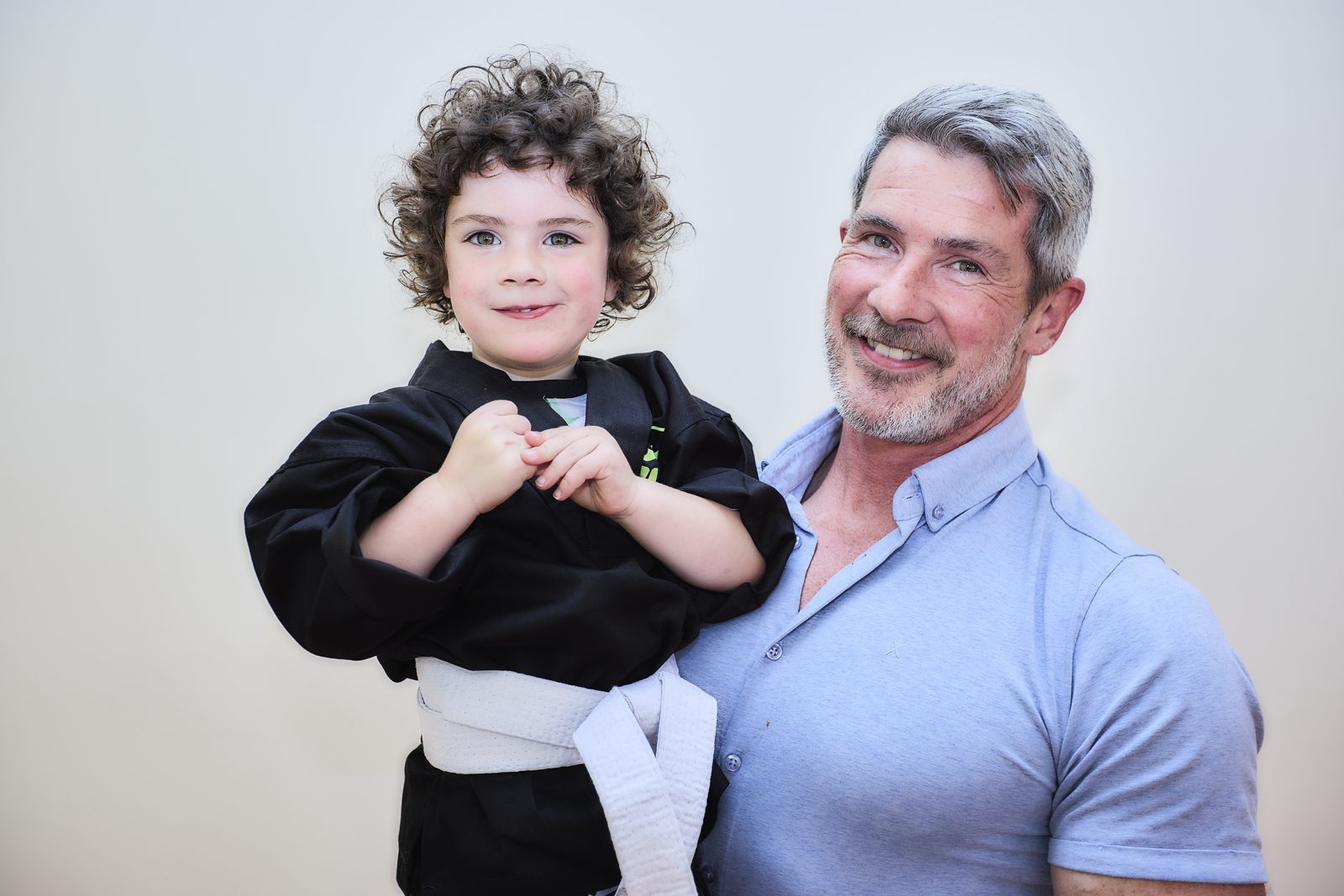 Parent and child smiling after a Little Ninjas martial arts class